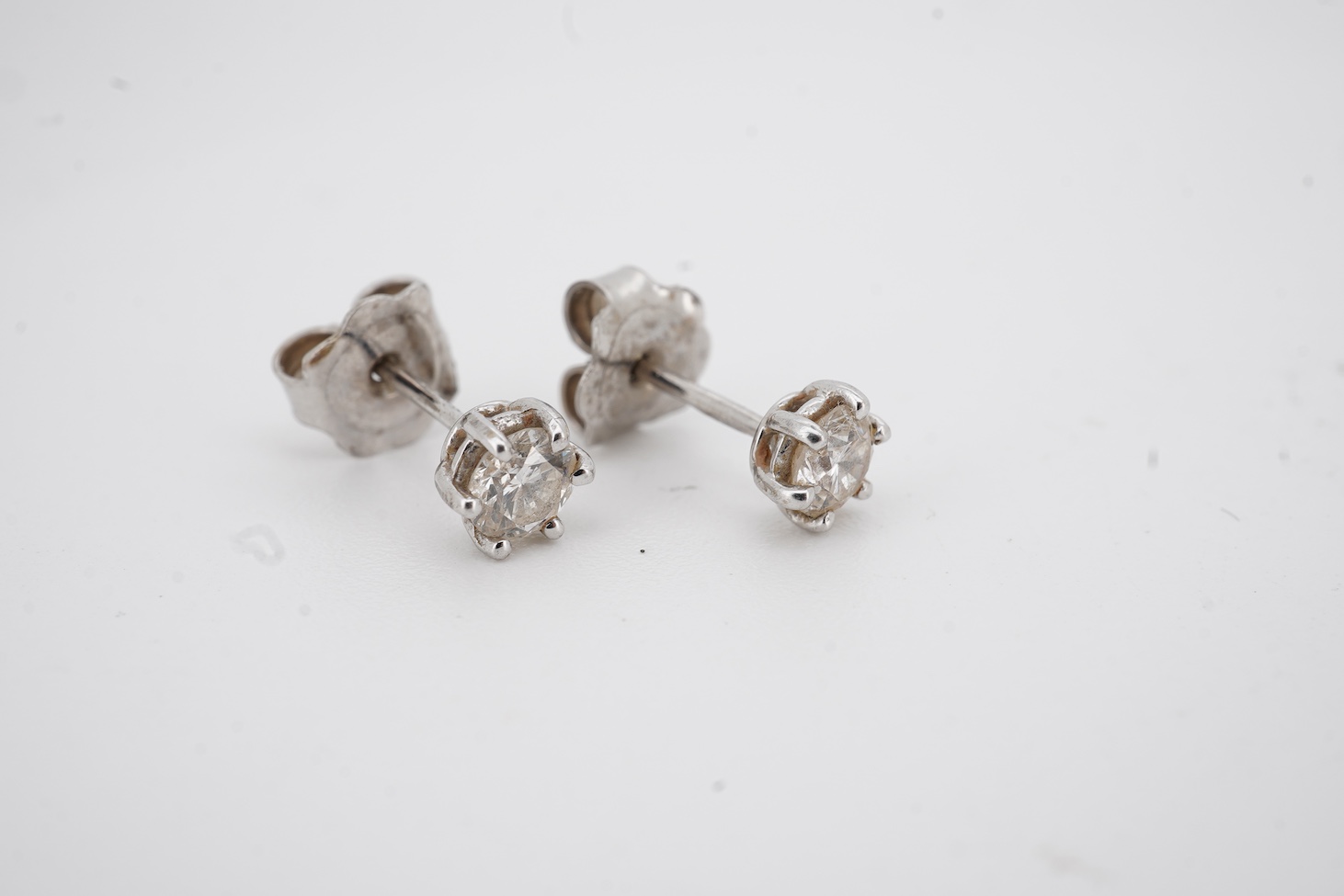 A pair of 18ct white gold and solitaire diamond set ear studs, each stone weighing approximately 0.15ct, gross weight 1.3 grams.